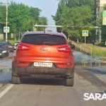 В Солнечном после дождя машины форсируют залитую водой дорогу